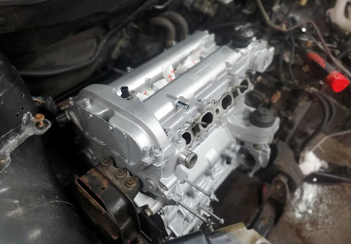 Freshly serviced silver engine installed in a vehicle